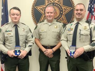 Gilmer County Sheriff Stacy Nicholson, center, presents lifesaving awards to Sgt. Josh Perigo, left, and Lt. Mark Patrick, right. (Gilmer County Sheriff’s Office photo)