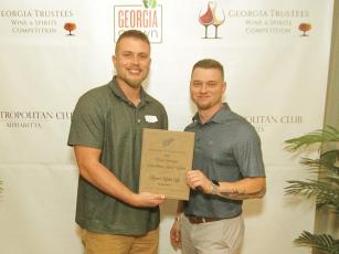 Reece’s Cider Co. owner Taner Reece and cidermaker Jake Fortenberry accept an award for Best Sparkling Hard Cider at the Georgia Trustees Wine and Spirits Challenge awards banquet in Alpharetta. 