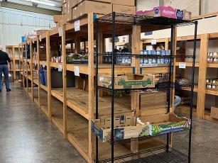 Shelves are bare where several shelf-stable food items would normally be stocked at the Gilmer Community Food Pantry. 
