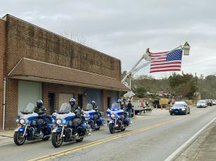 The procession carrying late Speaker of the Georgia House of Representatives and Gilmer County native David Ralston departs from Logan Funeral Home Tuesday, Nov. 22, en route to the Georgia Capitol in Atlanta, where he was to lie in state. Ralston, who passed away Nov. 16, represented House District 7 (Gilmer, Fannin and part of Dawson County) for almost two decades and led the Georgia House as its speaker since 2010. He was laid to rest Sunday following a public funeral service in Blue Ridge. (ETC Photo)