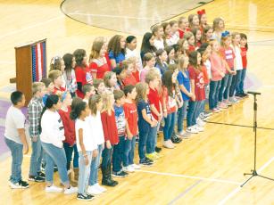 Singing proud on Veterans Day – The young members of the Ellijay Elementary School Chorus, under the direction of Katie Mayfield, lift spirits with their singing during an honorary Veterans Day program held Friday, Nov. 11. Due to rain, Gilmer County’s Veterans Day parade was cancelled and the honorary program moved indoors to the Gilmer High School Gym. 