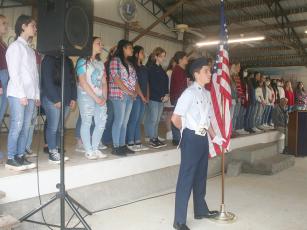 Cadet Chief Master Sgt. Blake Roach, of Ellijay’s Civil Air Patrol 507th squadron, stands as part of a color guard while the Gilmer High School Chorus performs at last year’s community Veterans Day program.