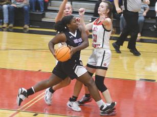 Lady Cat Amayah Jones draws contact in the lane in Gilmer’s matchup versus Sonoraville last Friday.