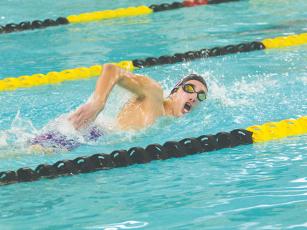 Gilmer’s Ian Berry (above) and Evan May (below) swim the 50-yard freestyle and backstroke in the 200-yard medley relay, respectively, at last Thursday’s meet in Calhoun.