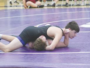 Clear Creek wrestlers Isaiah Goodwin (above) and Braelyn Nelson (below) are in control of their Dawson County opponents last Tuesday. Goodwin posted an undefeated record on the week.