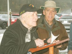 Daffodil Project ambassador Mike Weinroth, right, listens intently after introducing World War II veteran Hilbert “Hibby” Margol, left, to speak during a dedication ceremony for a new Daffodil Project garden at River Park. Margol, 98, was among the soldiers who liberated the Dachau concentration camp on April 29, 1945.