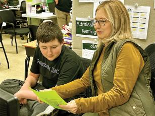 Janet Davis, Gilmer Mountain Education Dual Enrollment and Work-Based Learning Specialist, meets with student Hunter Holt.