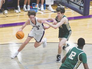 Gilmer junior Ryder Wofford drives the baseline versus Wesleyan last Tuesday, and he finished the game with nine points and seven rebounds. 