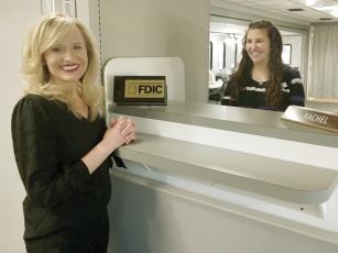 Amber Davenport, Ellijay United Community Bank vice president, left, and teller Rachel Bailey, right, are shown inside a mobile banking unit the local UCB branch is using while cleanup and repairs from recent water damage continue. 