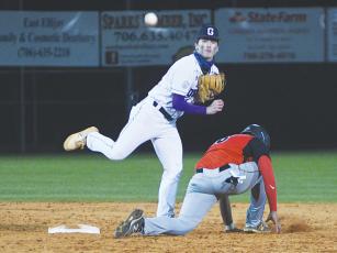 Gilmer High second baseman Aiden McClure attempts to turn a double play, and the Bobcats will take on Lumpkin County this week to continue their region schedule.