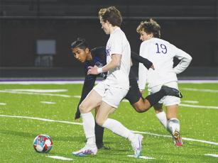 Gilmer High’s Jorge Flores (in black) looks to gain possession versus Lumpkin last Tuesday. Flores scored a goal and added two more along with an assist versus Pickens three days later.