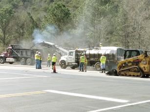 A crew from Colditz Paving, of Blairsville, puts new asphalt down on a stretch of Highway 515 near Greenfield Road last week.  