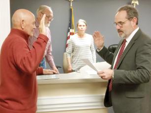 Don Callihan, left, is sworn in as East Ellijay Mayor by Gilmer County Probate Judge Scott Chastain, right. East Ellijay City Councilmembers Ed Forrester and Linda Smith are pictured in background. 