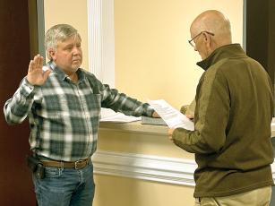 James Waters, left, is sworn in as an East Ellijay City Councilmember by Mayor Don Callihan, right.