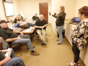 Gilmer County 911 Communications Officers Sgt. Donavie Laney, left, and Sgt. Ashley Laney, right, test the multitasking ability of the Citizens’ Law Enforcement Academy class with a split ear exercise and excerpts from actual 911 calls. 
