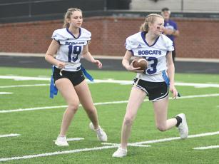 Junior Libby Pike looks for running room after receiving the ball from Annaliese Vaughn.