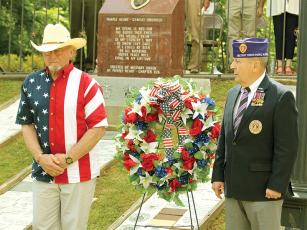 Rick Harris, left, the Gold Star father of First Lt. Noah Harris who was killed in action in Iraq, and Mike Pilvinsky, of the Military Order of the Purple Heart, right, place a wreath to honor those killed in America’s wars during a Memorial Day service held at Gilmer Veterans Memorial Park Monday, May 29.