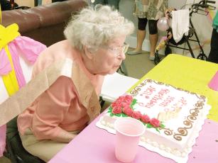 Nell Copeland blows out a ‘100’ candle on her birthday cake during a recent celebration at Brooks Hill Apartments. 