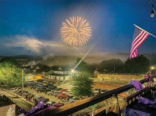 Fireworks light up the skies above downtown Ellijay on the Fourth of July. The city’s fireworks display, seen here from The Roof’s restaurant balcony on River Street, capped off the Independence Day festivities, which also included a morning parade through downtown. (Photo by Karleen Ferguson)