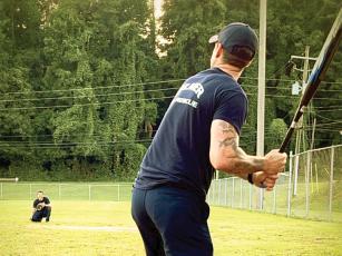 Gilmer County firefighter Nick Beetley, batting, practices his swing for the upcoming Battle of the Badges charity softball tournament. 