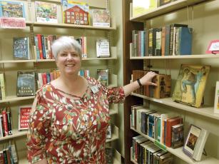 Becky Oliver, manager of The Bookshelf, arranges some of the classic edition “quaint books” that are available for purchase at the Friends of the Gilmer Library-run bookstore. 