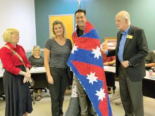 At a recent Ellijay City Council meeting, Ellijay Navy veteran Greg Sandway, third from left, receives a handmade Quilt of Valor from Lynda Case, left, and Randolph Case, right, both of the Pine Needle Quilt Guild. Greg is pictured alongside his wife, Janet Spivey Sandway. (Contributed photos)