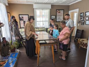 Leslie Thomas, left, describes items displayed in the Tabor House Museum’s Native American room.