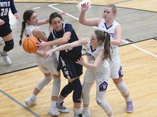 From left, Lady Cats Madison Bradshaw, Aliza Chastain and Lucy Ray converge on a White County Warrior last season.