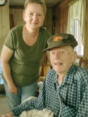 Burley Davis, 100, is pictured with his caretaker, Jennifer Griffin, at his Pleasant Gap residence. He served in both the European and Pacific Theaters of World War II.