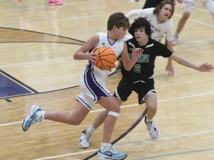 Clear Creek’s A.J. Callihan pushes the ball up court and helped the eighth graders  earn a comeback win versus White. 