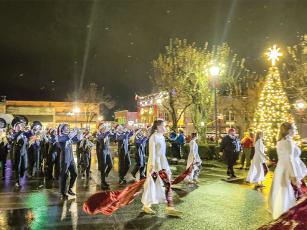 The Gilmer High School Band marches around the brightly-lit town square during the parade. (Robert Ferguson/Gilmer Chamber)