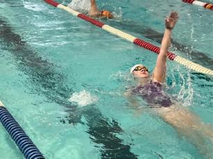 Gilmer’s Evan May swims the backstroke in the 200-yard medley relay at last Saturday’s Candy Cane Invitational.