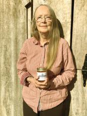 Lauretta Weaver holds a jar of her wassail jelly, also seen below, which the Gilmer County resident now has commercially produced.