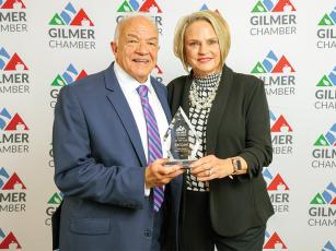 The Gilmer Chamber’s 2023 Citizen of the Year Del Land, left, holds the award with wife, Tamara, right. 