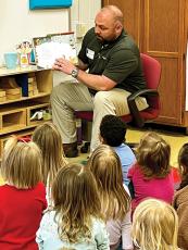 Josh Chancey, a Kids Ferst of Gilmer County board member, reads to children at a local elementary school. The childhood literacy organization distributes 1,000 books a month to children ages 0 to 5 in the county, and recently passed donating its 200,000th book since the program’s inception in 2007. 