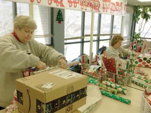 Melinda Cowan, left, and Janice Ross, right, were among the Gilmer Toys for Tots volunteer gift wrappers who worked to get presents wrapped for 162 families the week before Christmas.