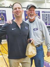 Head coach Jordan Hice became the Bobcats’ all-time basketball wins leader with 167 when Gilmer High defeated West Hall last Friday. Hice is congratulated by dad Gene Hice, who previously held the record with 166.